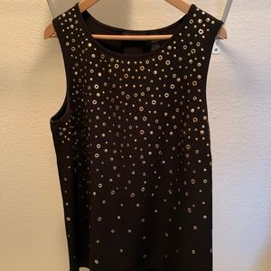INC sleeveless shirt with gold details.